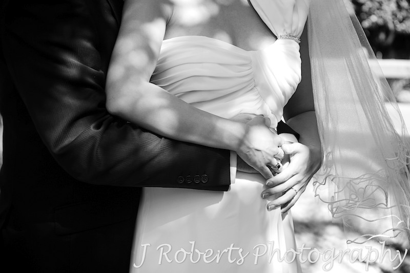 Bride and groom holding pregnant belly - wedding photography sydney